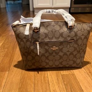 Brand new coach bag. Never used. Can be worn as a cross body too.